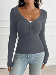 Detail of dark grey V-neck long sleeve top with ruching and decorative buttons