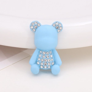 Detailed view of a blue resin bear charm with sparkling rhinestones for DIY accessories