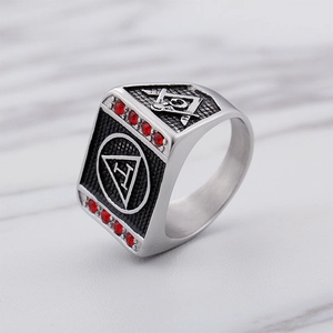 Macro view of men's Masonic ring with red rhinestones and engraved square and compass symbols