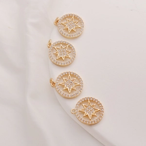 Close-up of 14K gold plated pendants with starburst design and zircon inlay detail