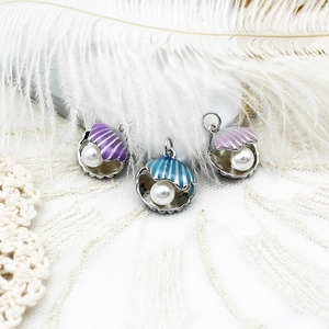 Detailed view of 18K gold plated enamel shell pendants with embedded pearls for DIY jewelry
