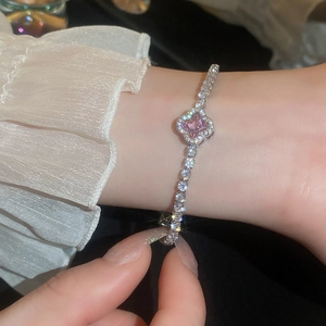 Close-up of elegant flower zircon bracelet with pink gemstone in silver finish