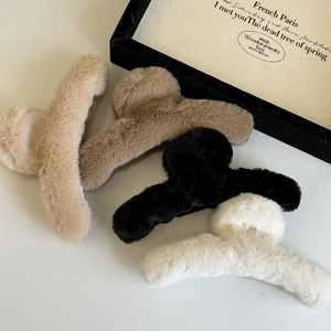 Macro detail of plush faux fur hair claws in beige, brown, black and cream white colors