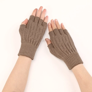 Detailed texture of brown cable knit fingerless gloves showing ribbing details and warm fabric