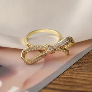 Elegant 18K gold plated bow ring with pavé-set zircons and adjustable opening for women