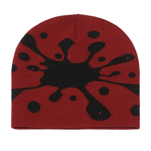 Close-up of the thick knit texture and red black mottled pattern of this beanie hat
