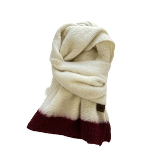 Soft cream knit scarf with dark red gradient edge and minimalist leather brand tag