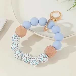 Silicone bead keychain wristlet with sky blue and wood beads on gold ring