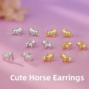 Detailed view of horse-shaped stud earrings in polished gold and silver finishes