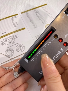 Macro shot of a 1.0ct moissanite pendant being tested with a diamond selector device