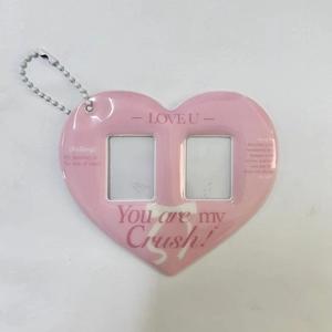 Detailed view of pink heart-shaped card holder with dual windows and silver bead chain