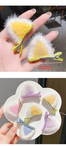 Detail view of 5cm plush cat ear hair clips with silver metal duckbill clips
