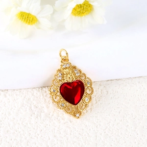 Luxurious gold-plated heart pendant with red gemstone and crown pattern on white surface