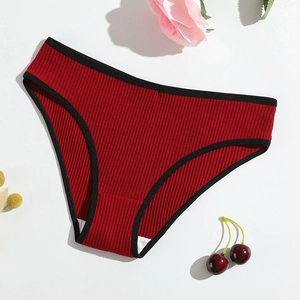 Close-up of ribbed cotton panties in dark red with black trim and a low-rise cut