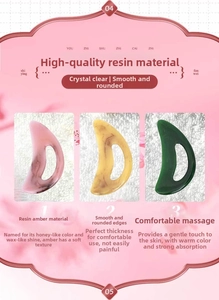 Three crescent-shaped resin massage tools in pink, yellow, and green on a pink background