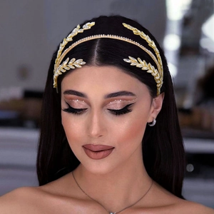 Detailed view of bridal headband with golden leaves and sparkling crystal rhinestones