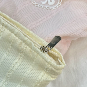 Detail of the high-quality metal zipper and striped embroidered fabric texture