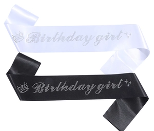 Close-up of glitter fabric birthday girl sashes with rhinestones in black and white