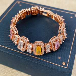Detailed close-up of a luxury rose gold bracelet featuring colorful zircon stones and diamonds