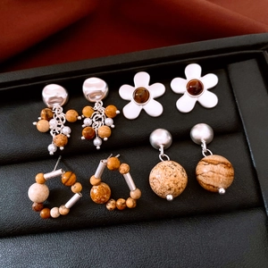 Detail view of four vintage beaded earrings with silver metal and natural stone textures