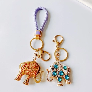 Detail view of cartoon elephant keychains with gold plating, enamel and sparkling rhinestones