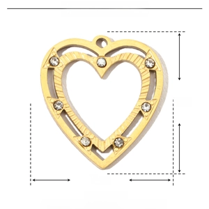 Macro view of gold heart pendant with white crystals and dimension markings