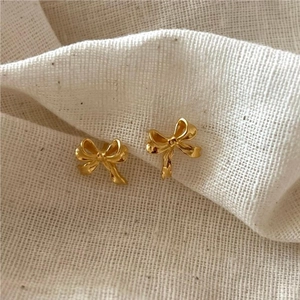 Elegant 925 sterling silver bow stud earrings with a polished gold finish for women