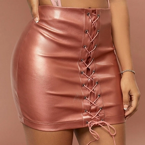 Close-up of rose gold PU leather mini skirt featuring front lace-up metallic eyelets