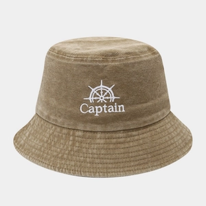 Detailed embroidery of a nautical wheel and Captain text on a washed cotton bucket hat