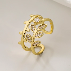 18K gold plated leaf open ring with sparkling cubic zirconia on a minimalist background