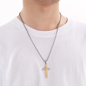 Detail of silver twist chain with a gold and silver layered hollow cross pendant