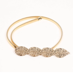 Detailed view of golden elastic metal belt featuring four hollow leaf designs on white backdrop
