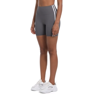 Detail of grey high-waisted yoga shorts with side stripes and form-fitting fabric