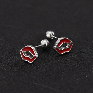 Close-up of red lip shaped titanium steel stud earrings with secure screw ball backings