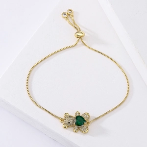 Adjustable gold bracelet featuring green heart and bear charms with zircon inlays