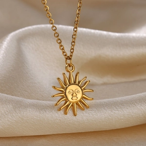 Double-layered gold stainless steel sun pendant necklace on champagne silk background