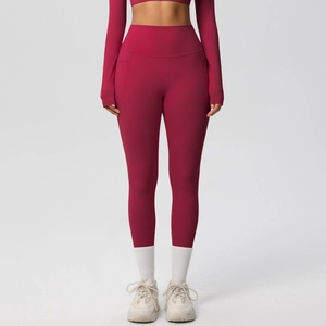 Close-up of functional side pocket on burgundy high waist yoga leggings for fitness