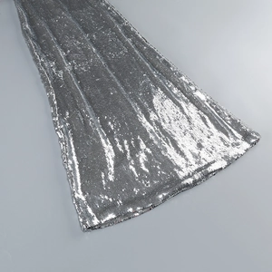 Close-up of high-density silver sequins on evening dress showing radiant texture