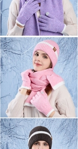 Detail of pink knitted winter set with scarf and touchscreen gloves on snowy background