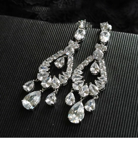 Macro shot of silver-plated waterdrop earrings with tiered cubic zirconia inlay detail