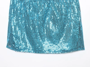 Detailed view of shimmering blue sequins on elegant spring dress with neat edge finish