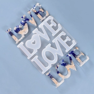Macro view of LOVE letter silicone mold with heart shape and blue resin samples