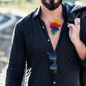 Rainbow graffiti temporary tattoo with red KISS text on a male model's chest
