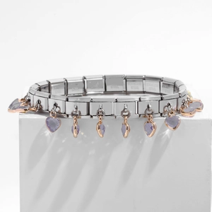 Detail showing stainless steel charm bracelet with purple heart crystals on white pedestal