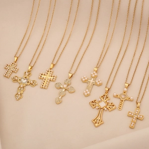 Detailed collection of eight gold cross necklaces with pearls and crystal stone accents