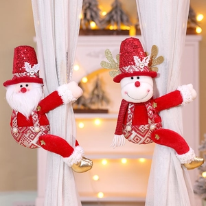 Detailed view of plush Santa and Snowman curtain tiebacks with shiny red sequins