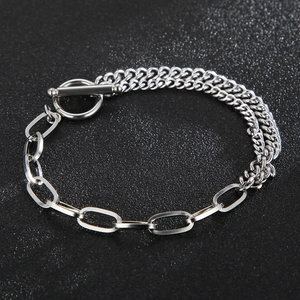 Macro shot of a dual-layer stainless steel Cuban link bracelet with OT toggle clasp
