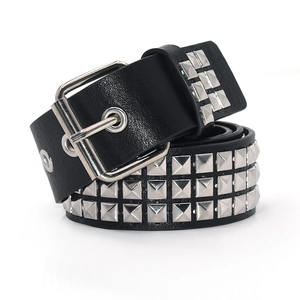Detail of a black punk leather belt with triple row silver pyramid studs and metal buckle