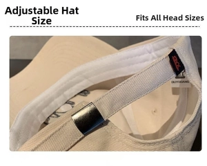 Detail of adjustable metal buckle and cotton fabric on beige baseball cap strap