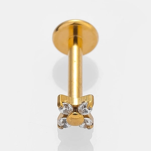 Macro shot of gold-plated clover labret stud earring with four clear cubic zirconia stones